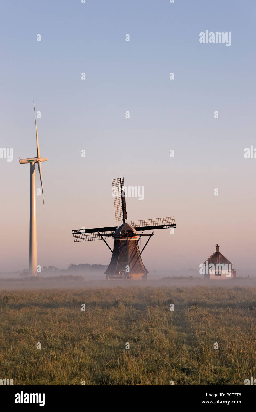 Wind turbine and windmill. De Babuurstermolen, Tjerkwerd, Friesland, Netherlands. Stock Photo