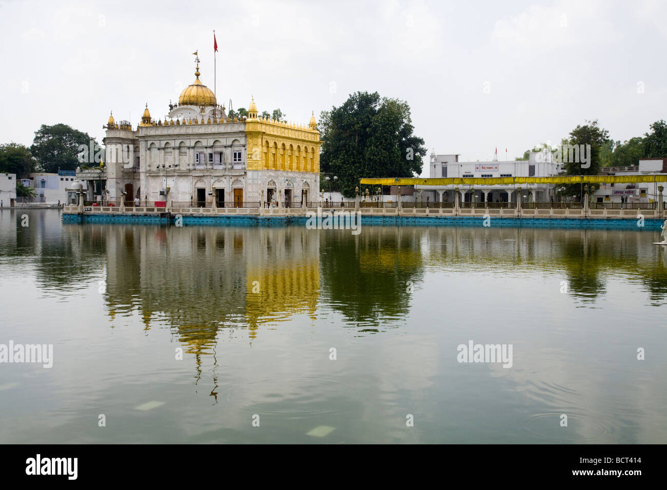 Sri Durgiana Hindu Temple, built in the style of the Sikh's Golden Temple, with a water tank and domed shrine. Amritsar. India Stock Photo