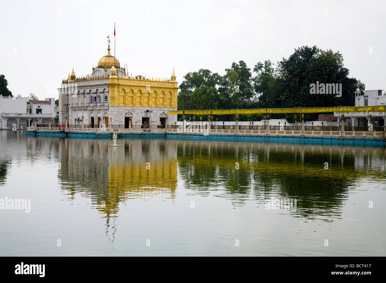Sri Durgiana Hindu Temple, built in the style of the Sikh's Golden Temple, with a water tank and domed shrine. Amritsar. India Stock Photo