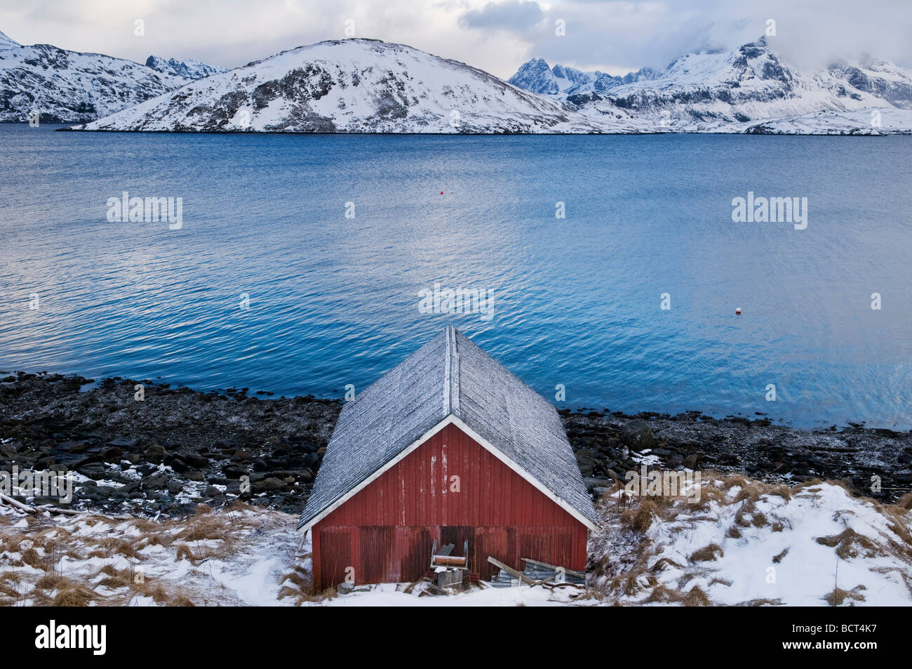 snow covered boat shed on shore of Selfjord in winter 