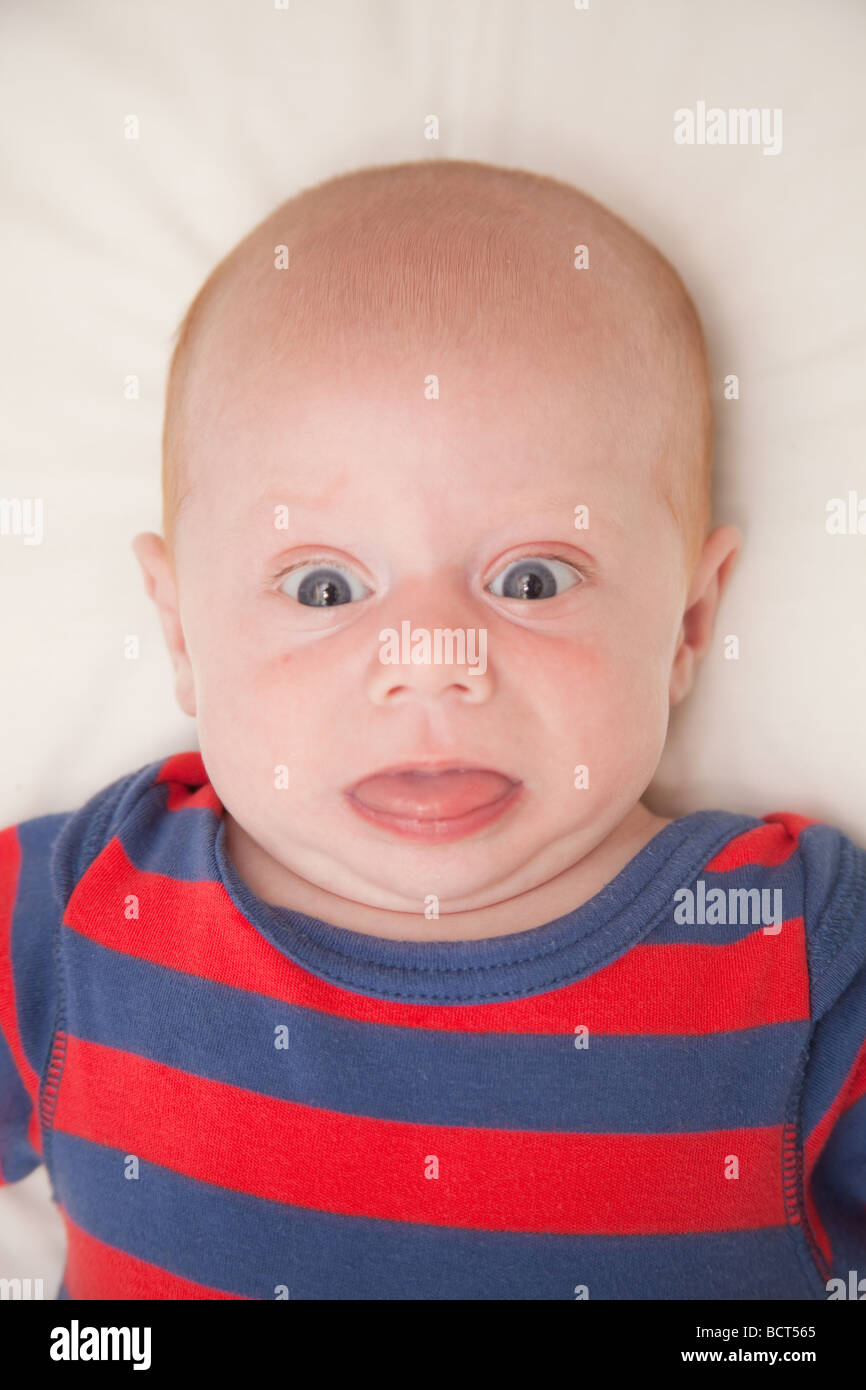 Two month old baby boy wearing a red and blue striped suit, London, England. Stock Photo