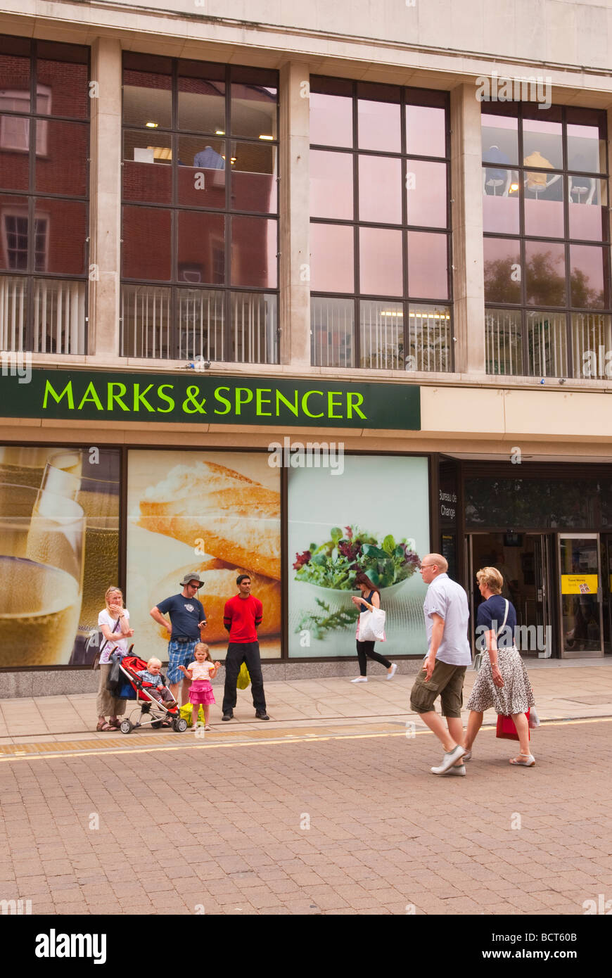 Marks and Spencer food store entrance in Norwich Norfolk Uk with people passing by Stock Photo