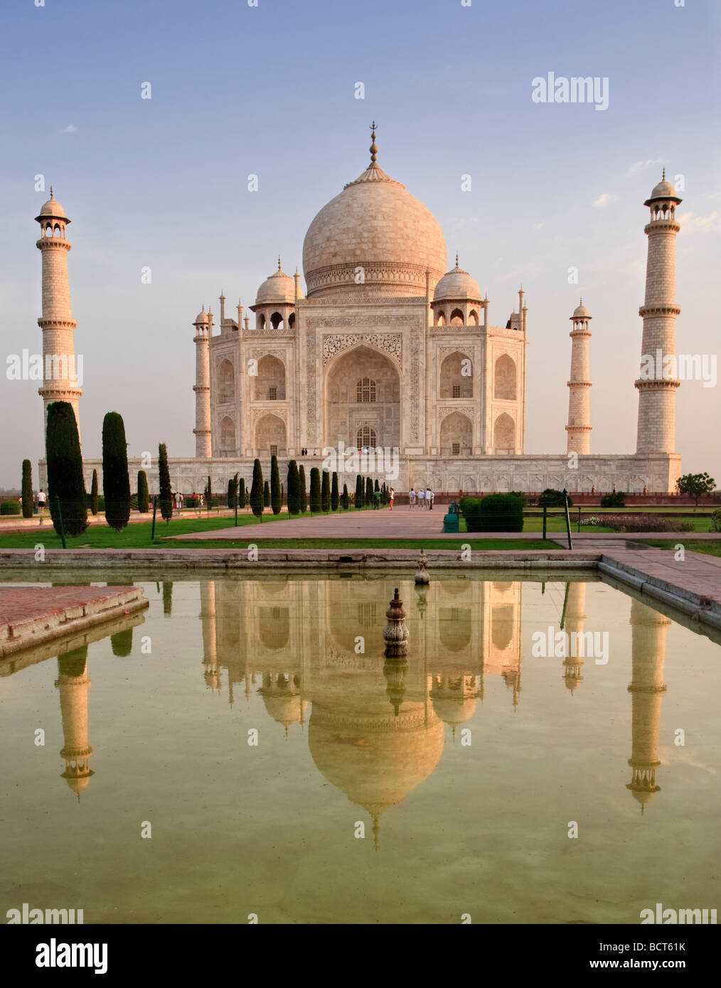 Taj Mahal Taj Mahal and reflecting pool, water feature. Front view of memorial at first light, sunrise. Horizontal. Agra, India. Stock Photo