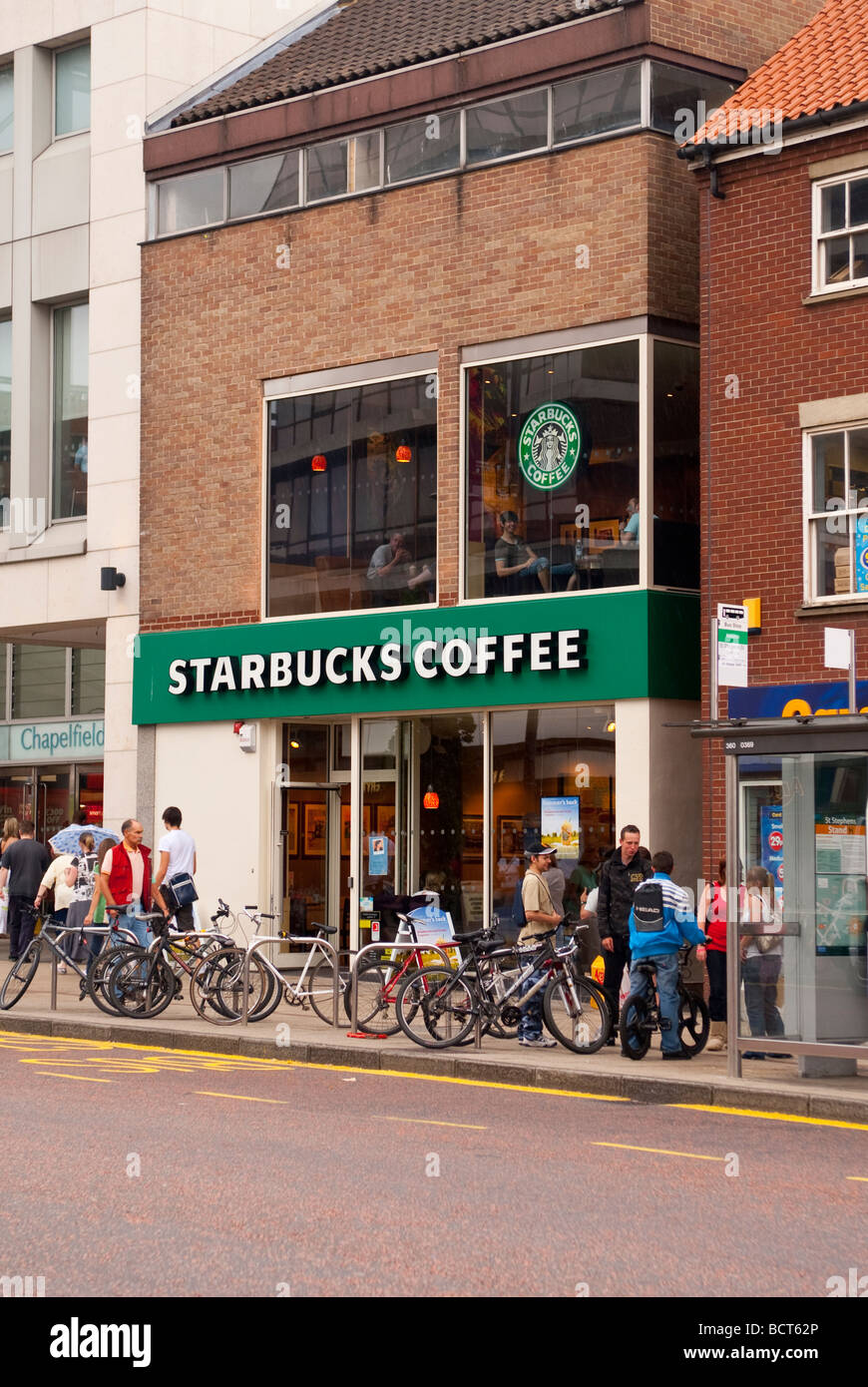 A Starbucks Coffee shop store with people outside in Norwich Norfolk Uk