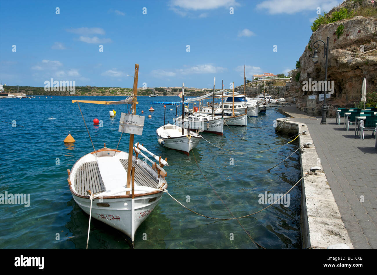Fishing boats in the harbour at Cales Fonts near Es Castell on the Balearic island of Menorca Stock Photo