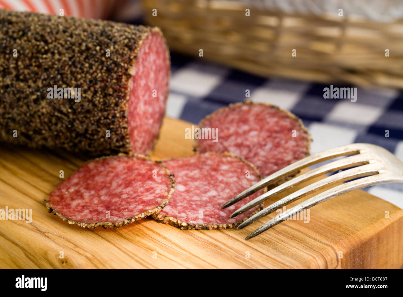pepper crusted salami sausage and slices Stock Photo Alamy