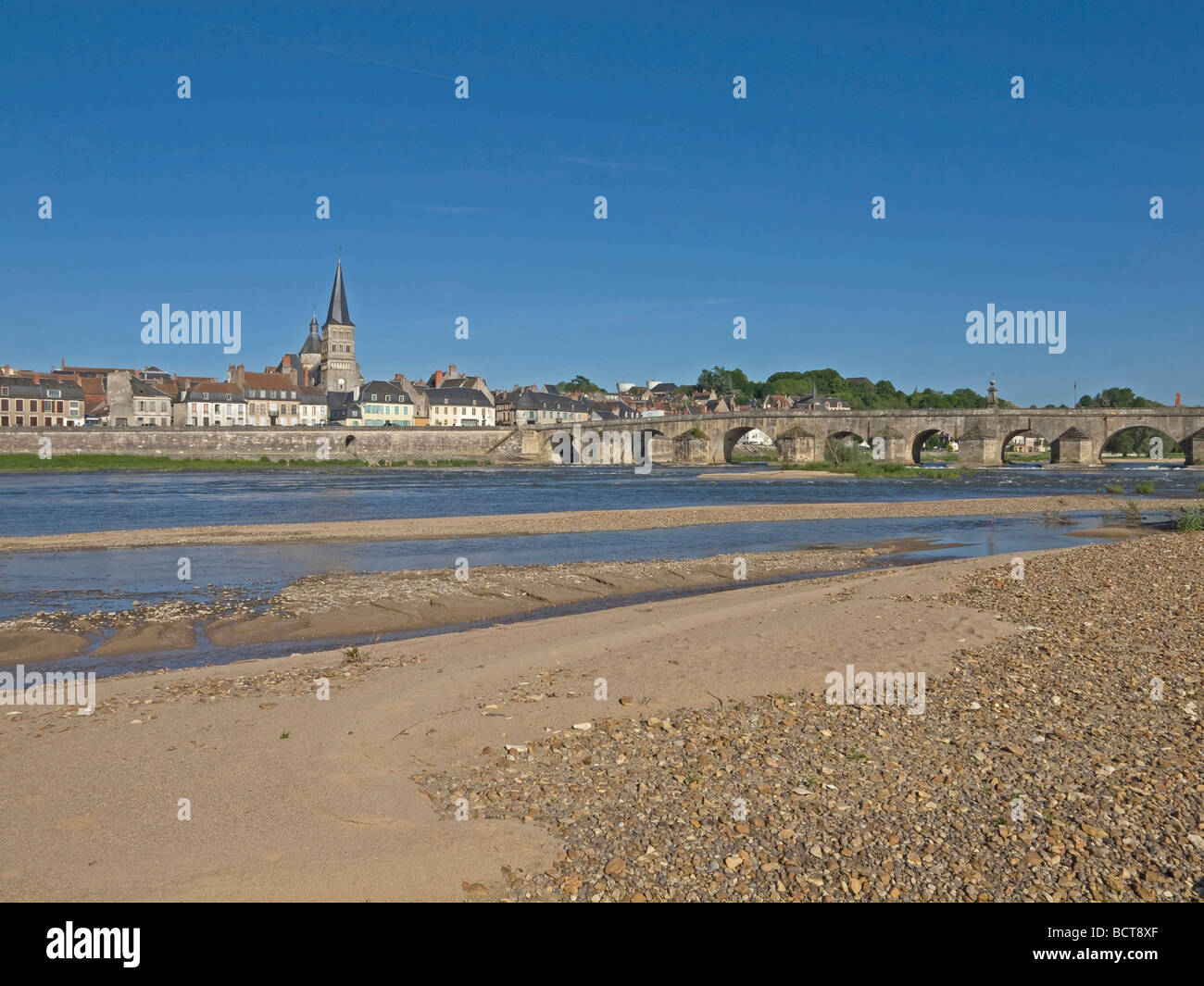 river Loire at bank with sand in the background town La Charite sur Loire at the bridge Stock Photo
