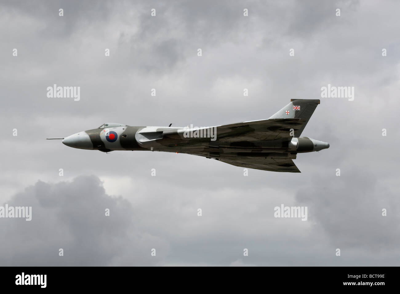 Vulcan XH558 on a low level fly by against stormy clouds Stock Photo