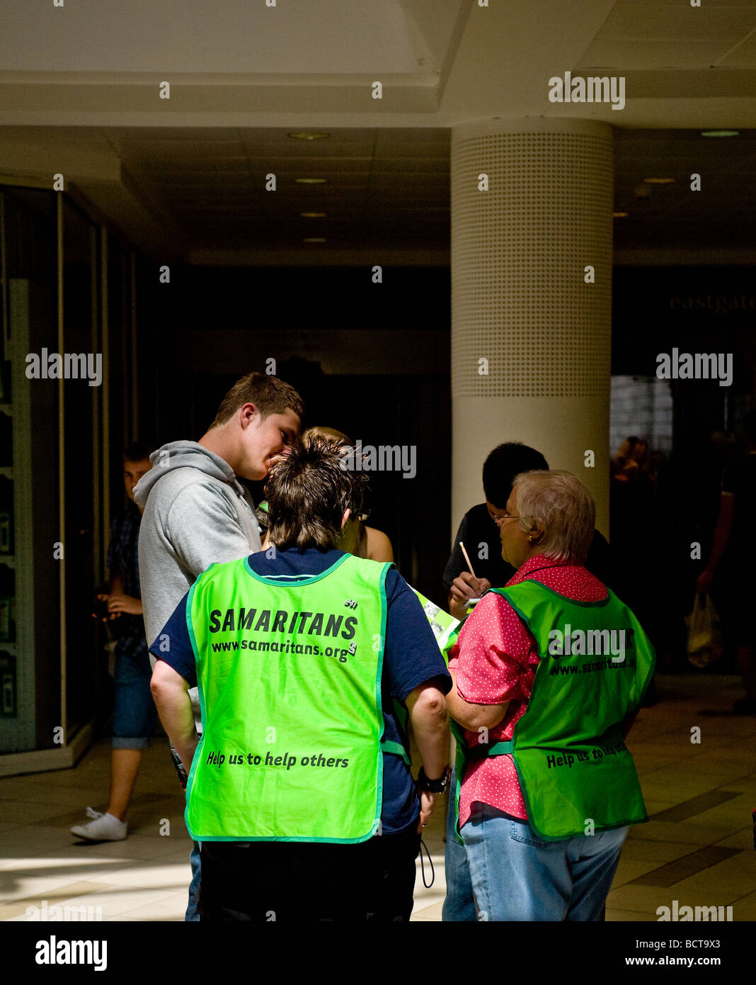Volunteers From The Charity The Samaritans Talking To Members Of The 