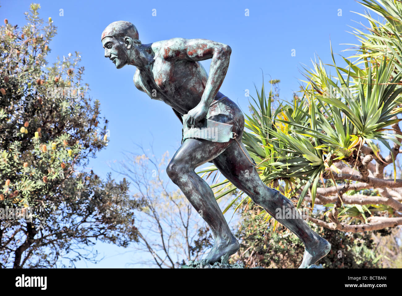 Bronze statue of an Australain lifesaver near a beach with belt and rope Stock Photo