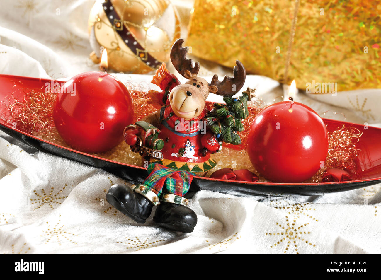 Red bowl with round candles and moose, reindeer Stock Photo Alamy
