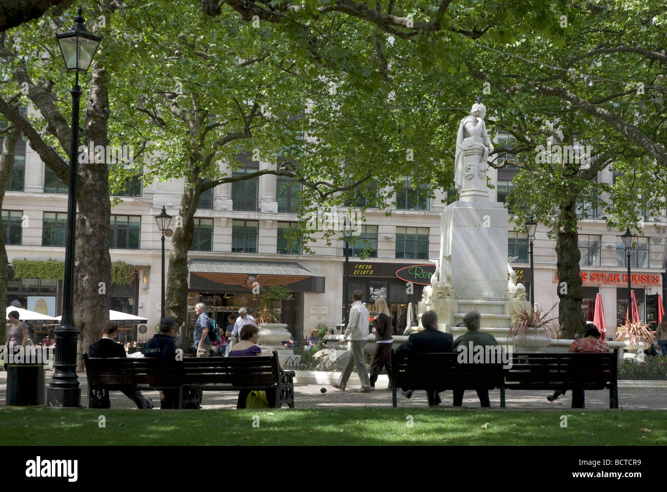 Office workers in Leicester square at lunchtime, London UK Stock Photo