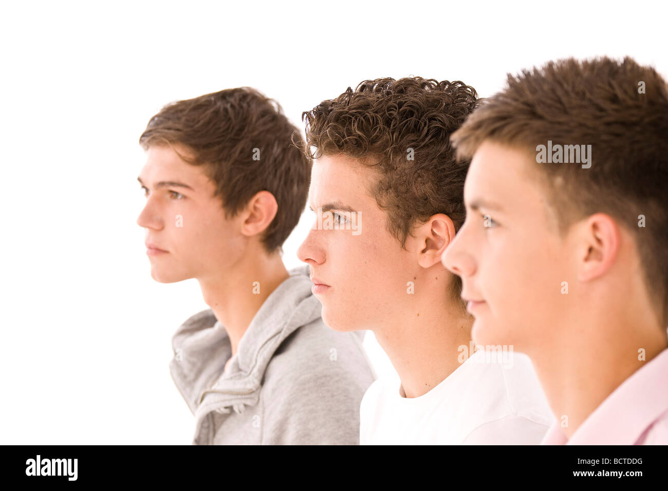 Three boys next to each other, profiles Stock Photo