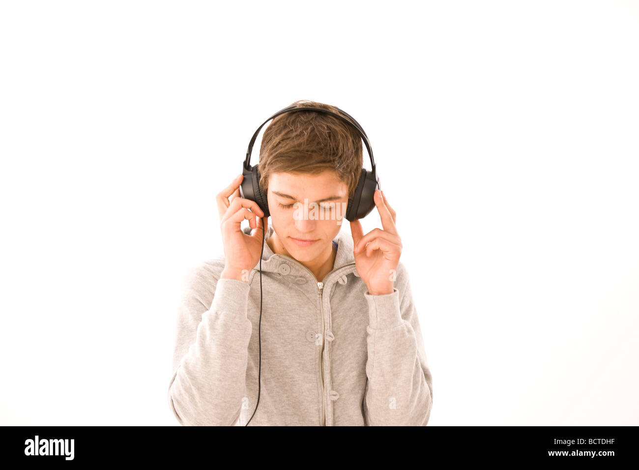 Boy listening to music on headphones Stock Photo