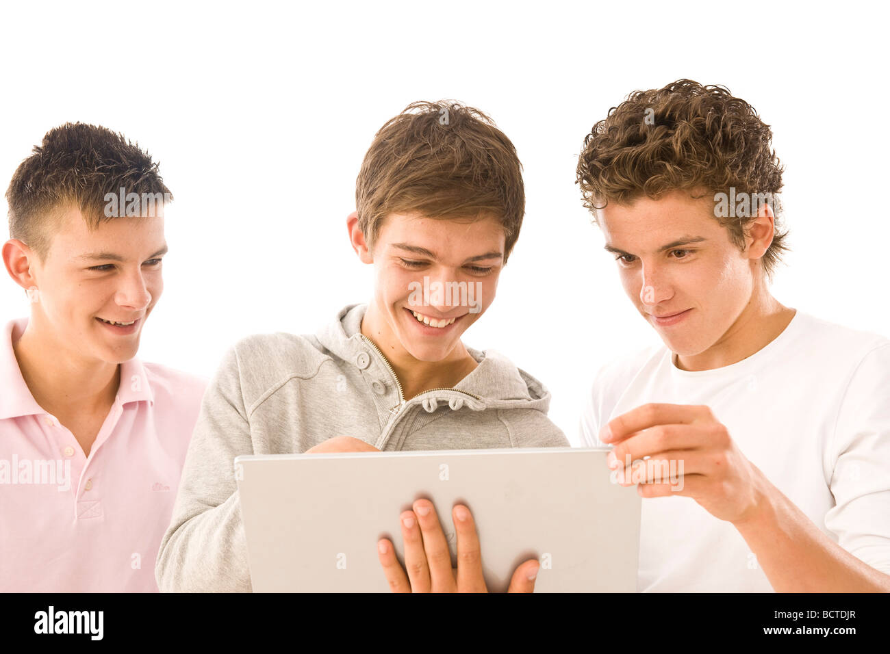 Three boys working on a laptop Stock Photo