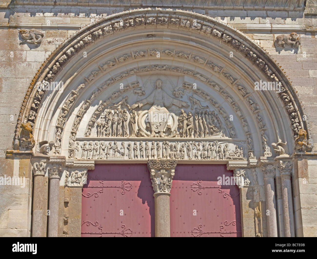 door with arch and sculptures at the church Sainte Marie Madeleine Stock Photo