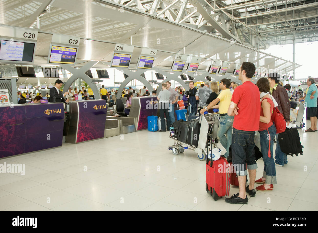 Passengers at the check in desk, Suvarnabhumi Airport, Bangkok, Thailand, Asia Stock Photo