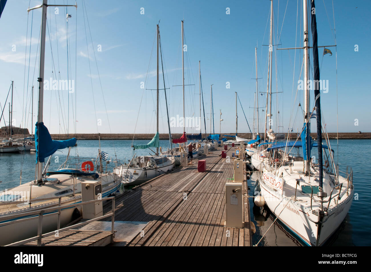 Yachts moored on the jetty at the Venetian harbour in Chania, Crete, Greece. Stock Photo