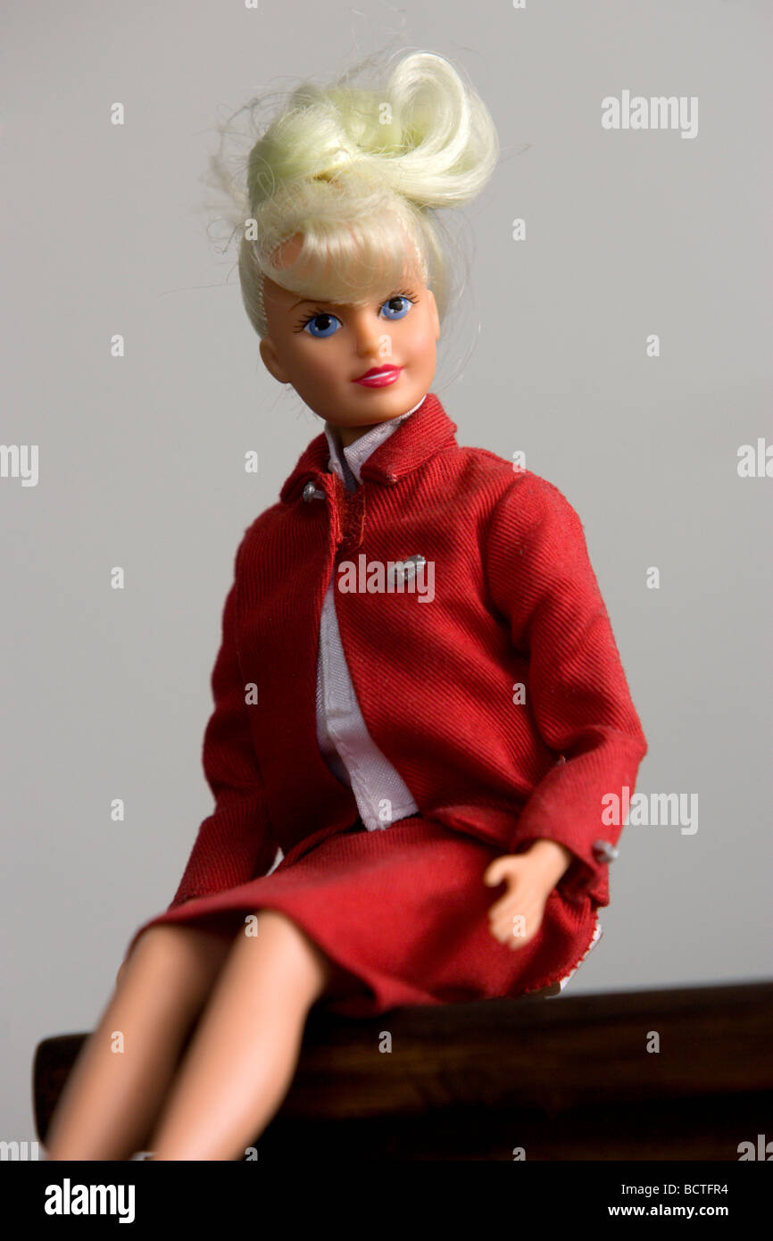 Blonde Virgin Atlantic cabin crew air hostess flight attendant Sindy Doll pictured in red uniform. Stock Photo