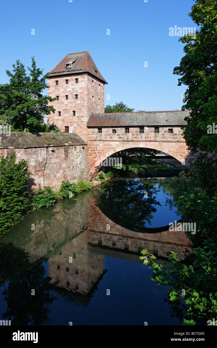 Old city wall with arched Steubenbruecke bridge, tower, Pegnitz, river, reflection, old town, Nuremberg, Middel Franconia, Fran Stock Photo
