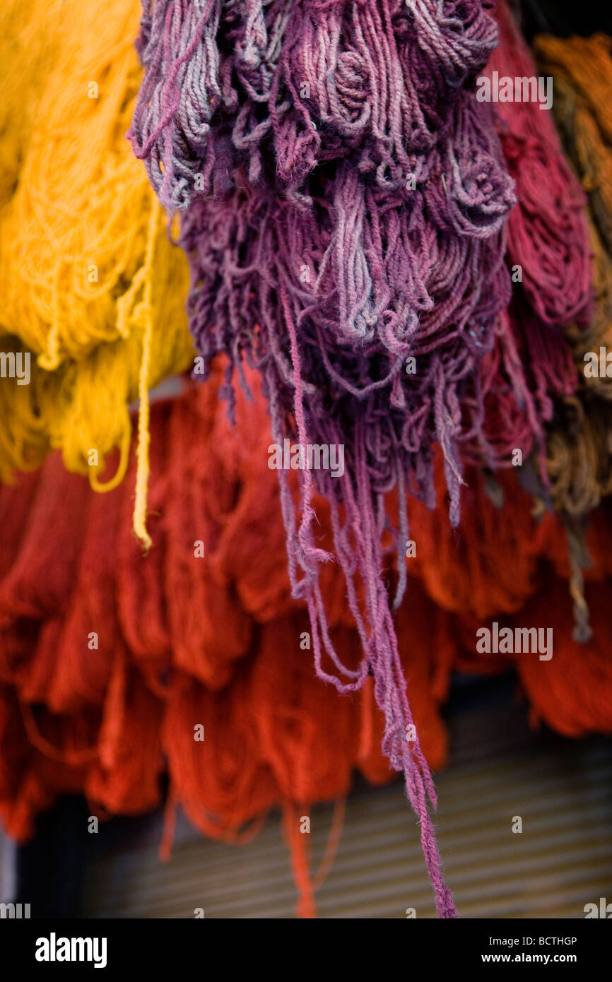 Dyed wool strings hanging dry on a narrow market alley (souk or souq) in Marrakech, Morocco. Stock Photo