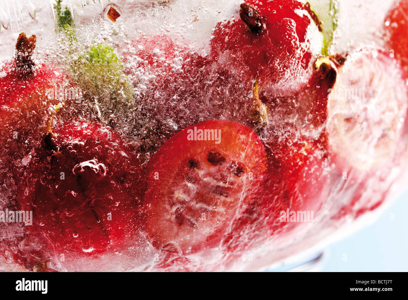 Gooseberries frozen, in a block of ice Stock Photo