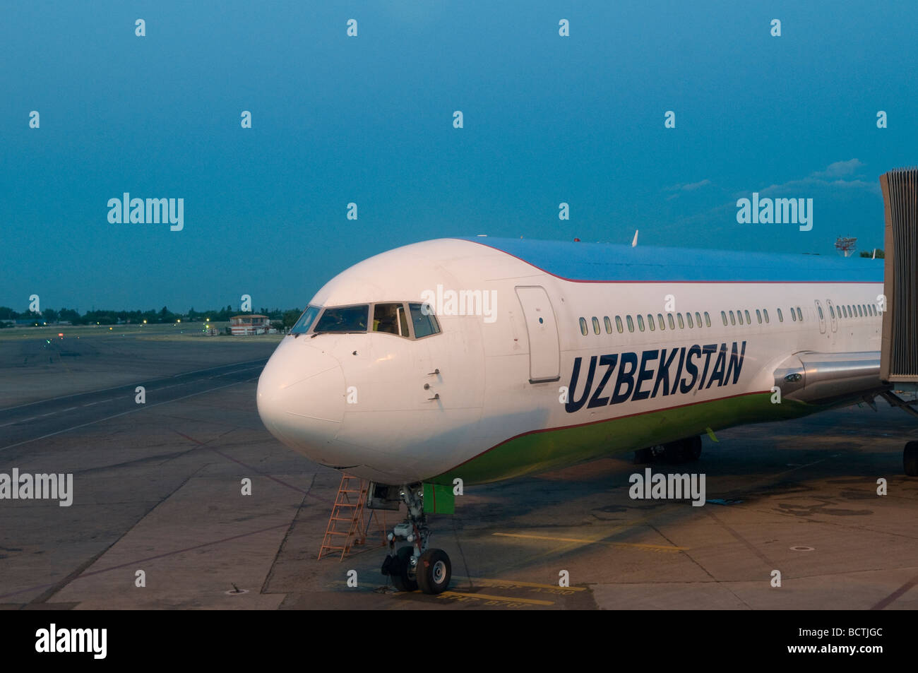 An airplane of National Air Company Uzbekistan Airways stands on the tarmac at Tashkent International Airport Uzbekistan Stock Photo