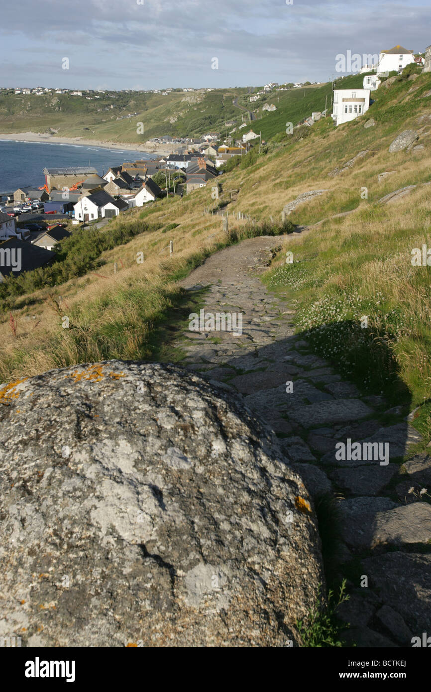 Area of Sennen, England. Coastal path leading from Pedn-men-du cliff into Sennen Cove Harbour. Stock Photo