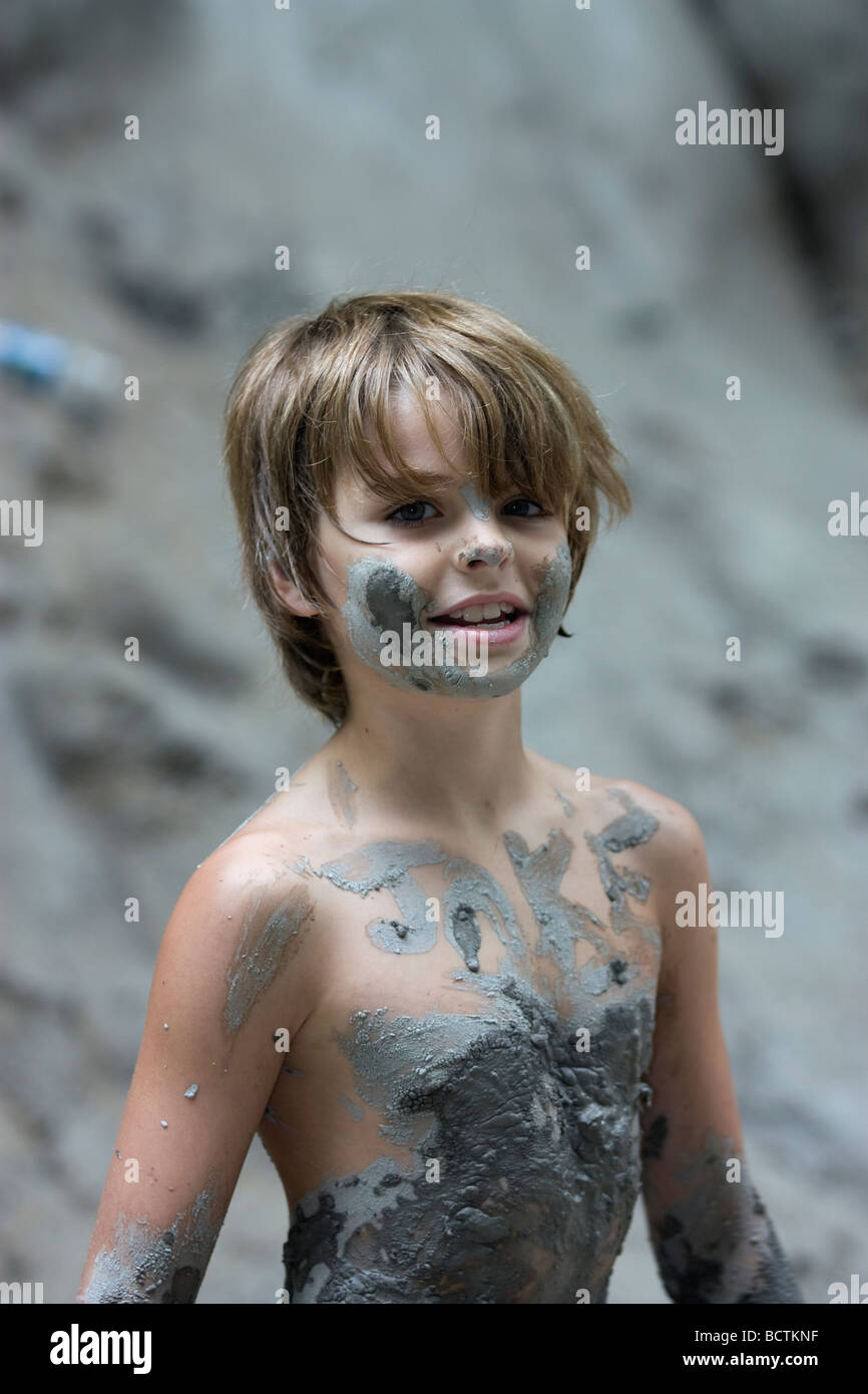 Young boy covered with mud Stock Photo