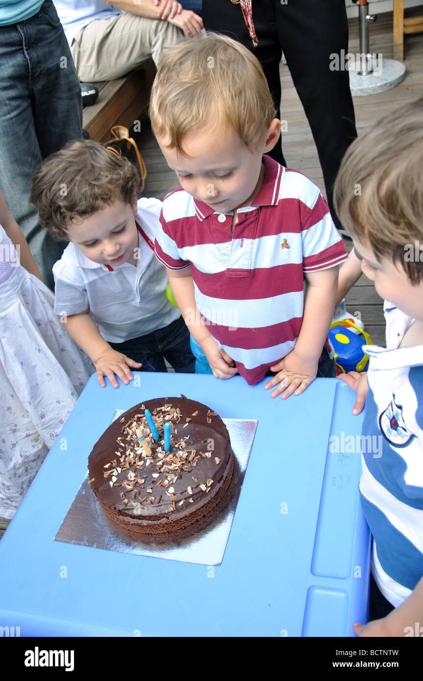 Blowing out candles at toddler's birthday party, Wimbledon, Greater London, England, United Kingdom Stock Photo