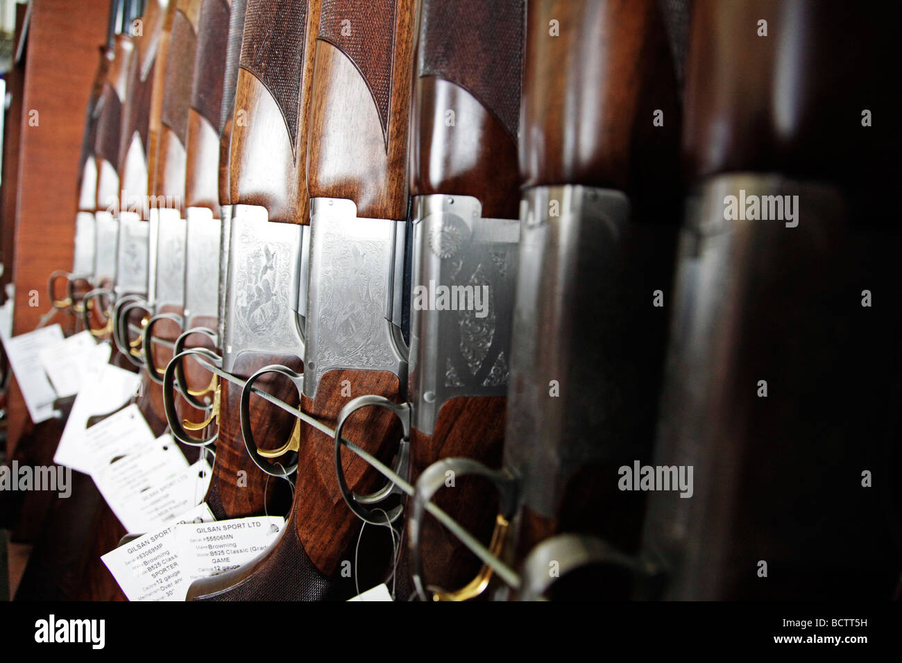 Shotguns on secure display at a country fair Stock Photo