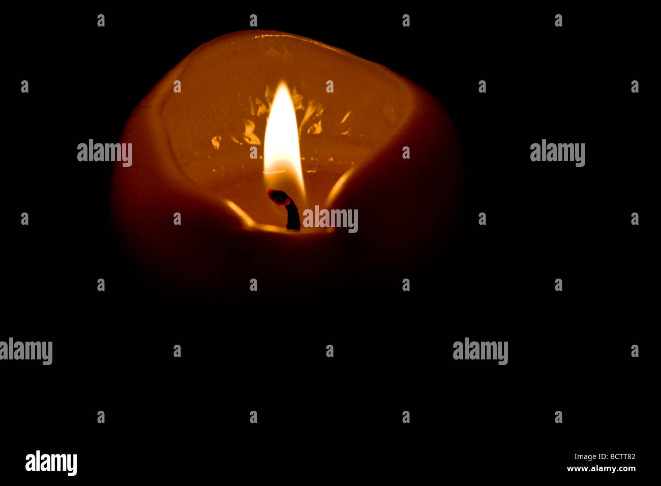 A candle lit surrounded by darkness Stock Photo Alamy