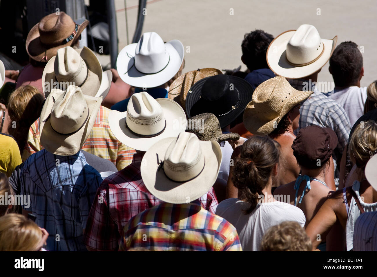 A crowd of people mostly wearing cowboy hats. Stock Photo