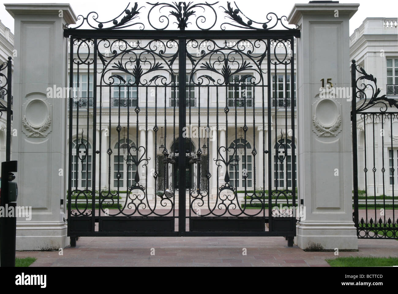 entrance and gate in front of luxurious mansion Stock Photo