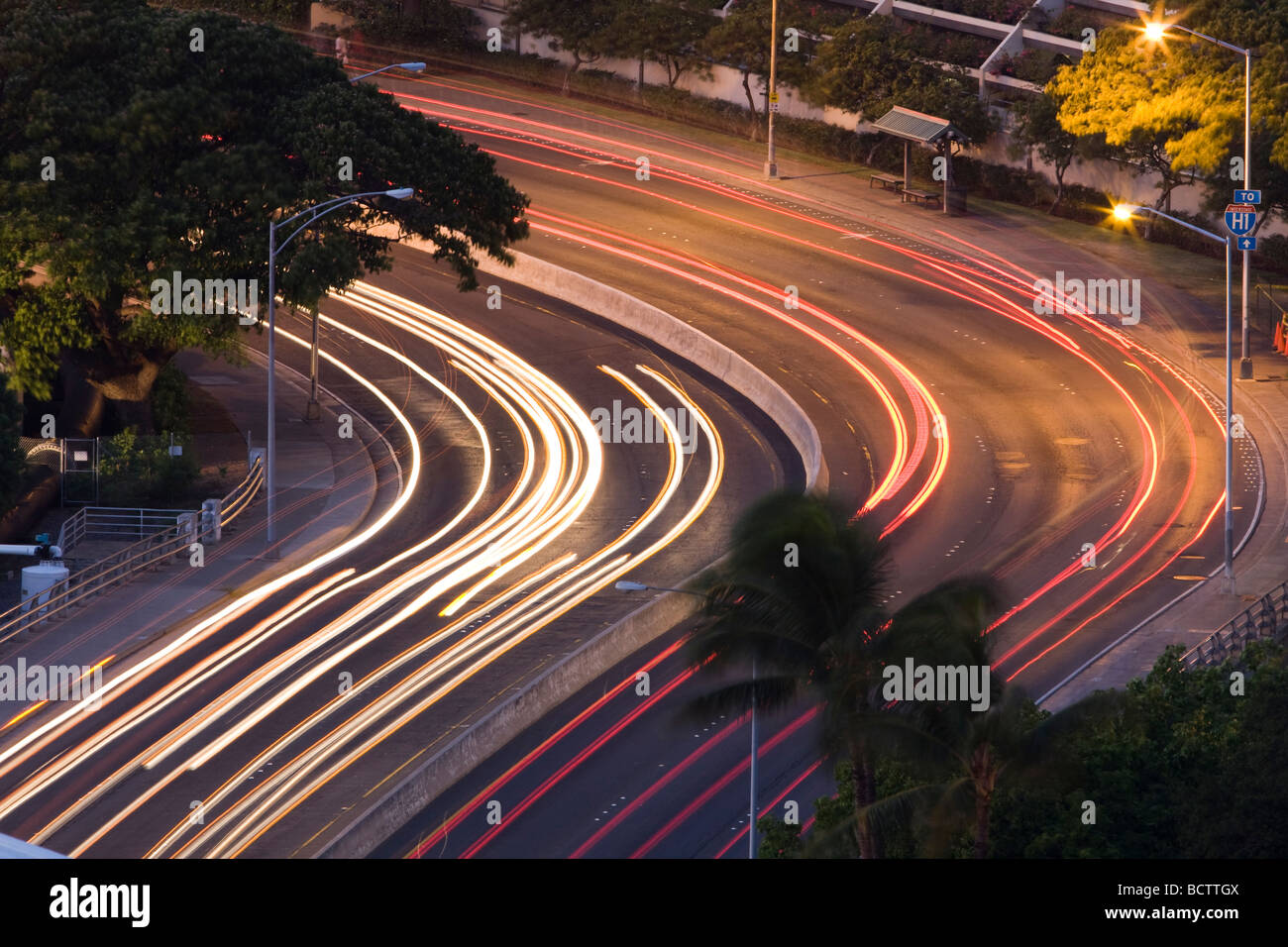 A long exposure makes the traffic lights stream around a corner on a