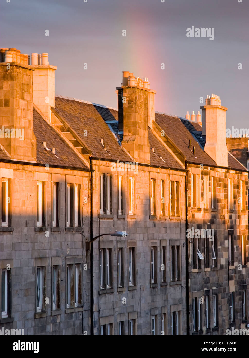 Golden light on the sandstone tenement flats of Easter Road Edinburgh Stock Photo