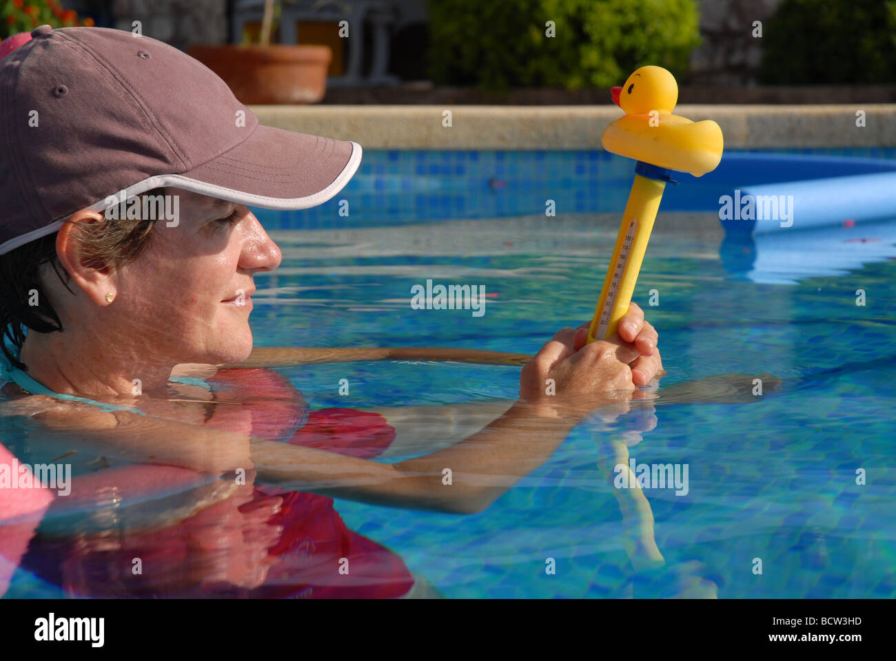 Reading a water thermometer in swimming pool, checking water temperature  Stock Photo - Alamy