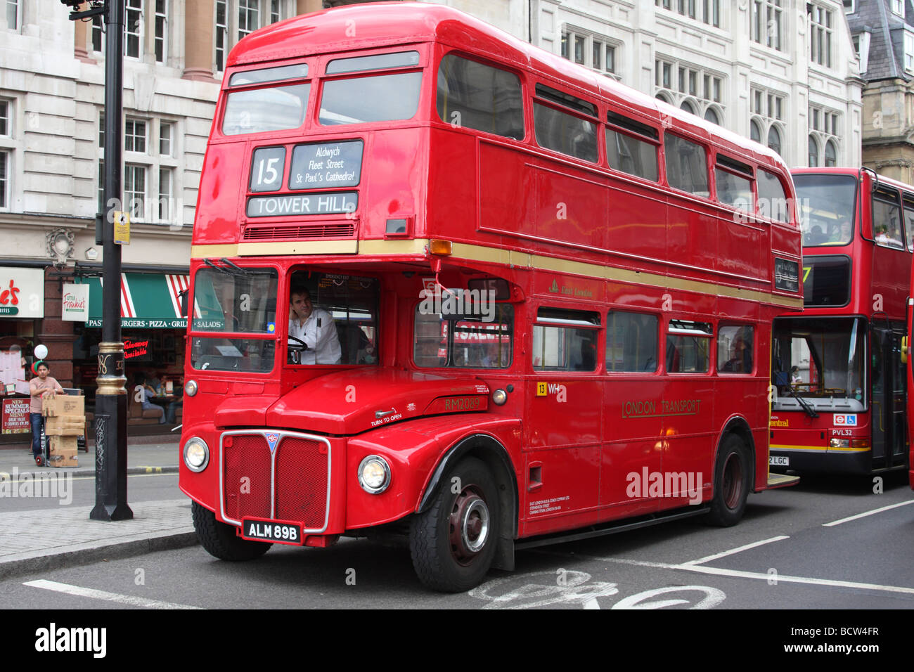 A red London Routemaster bus on a London street. Stock Photo