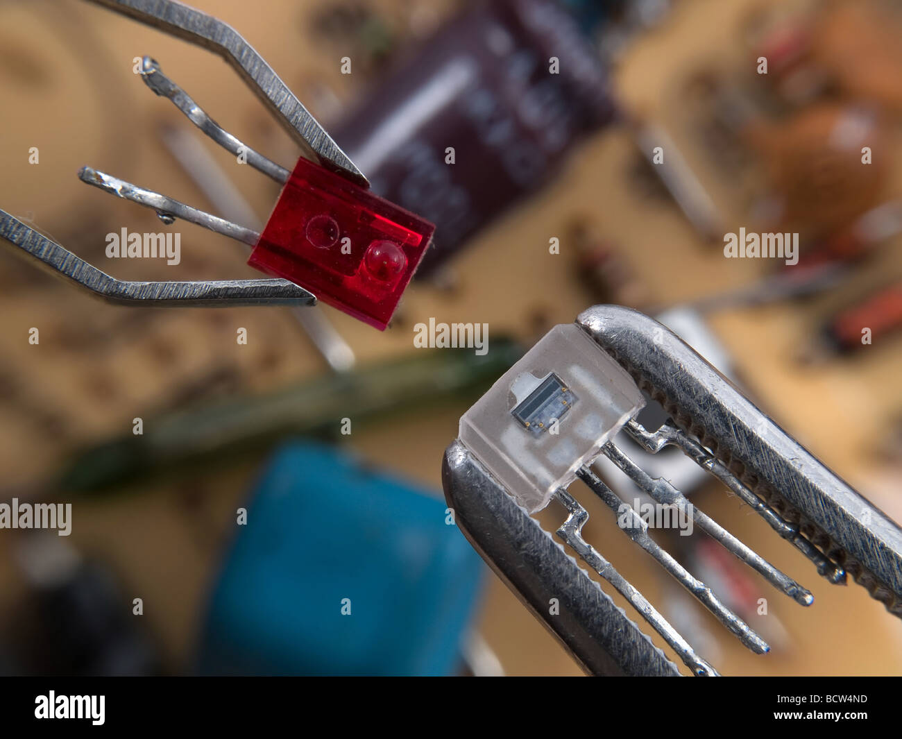 Optocoupler and LED in pincers electronic assembly macro Stock Photo Alamy