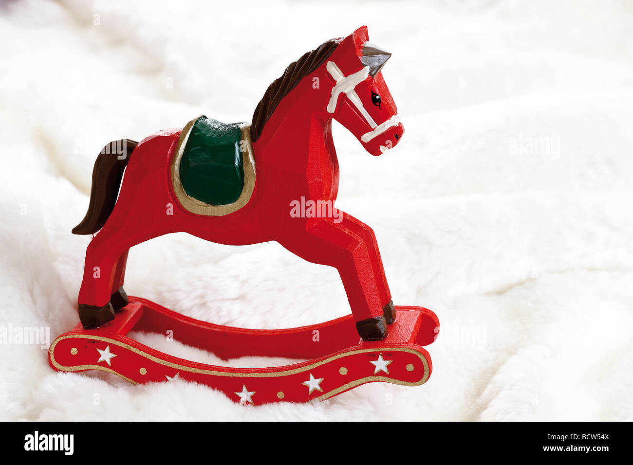 Miniature rocking horse on fur blanket Stock Photo Alamy