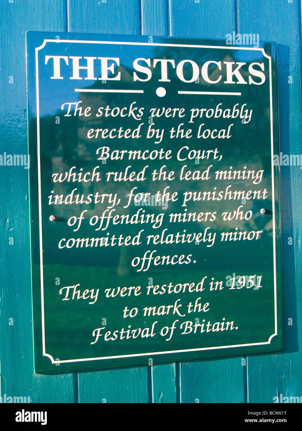A sign about the stocks in the Village of Eyam, in the Peak District Derbyshire England UK Stock Photo