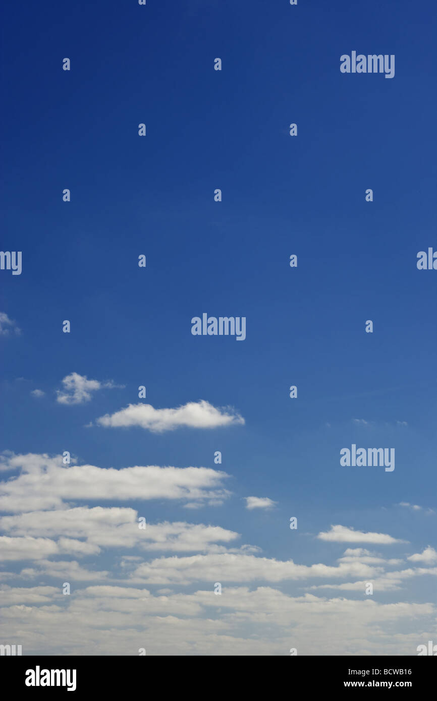 blue sky with white fluffy clouds background Stock Photo - Alamy