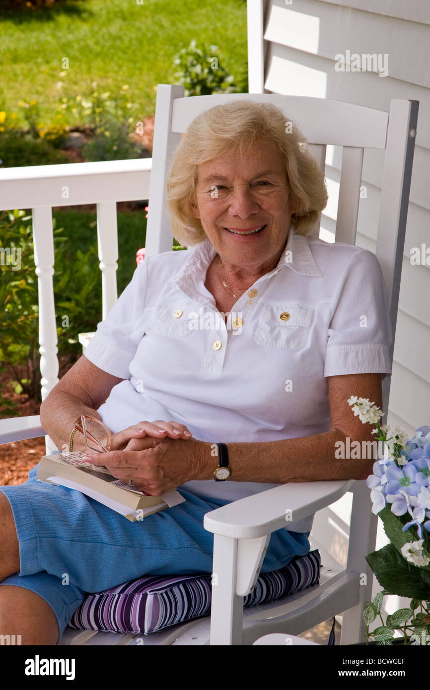Portrait of elderly woman seated on the porch of a Wells Maine