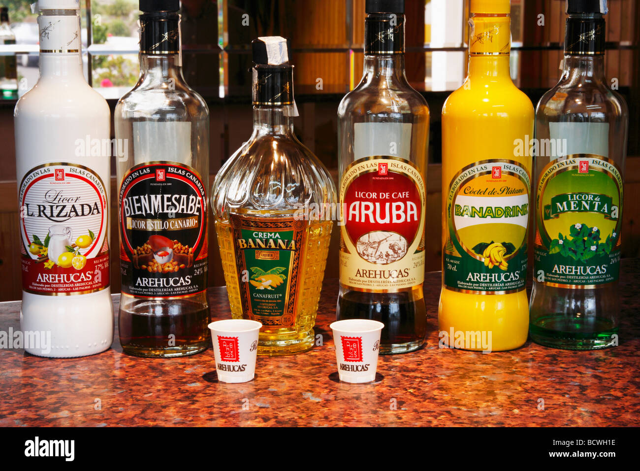 Bottles of rum based liqueurs in Arehucas Rum distillery in Arucas on Gran Canaria in the Canary Islands Stock Photo