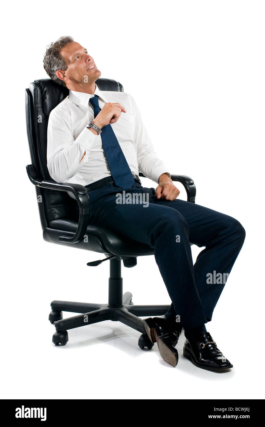 Dreamful pensive businessman sit on his chair isolated on white background Stock Photo