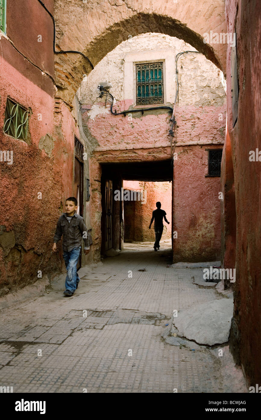 A narrow alley (souk or souq) in Medina, old town of Marrakech, Morocco. Stock Photo