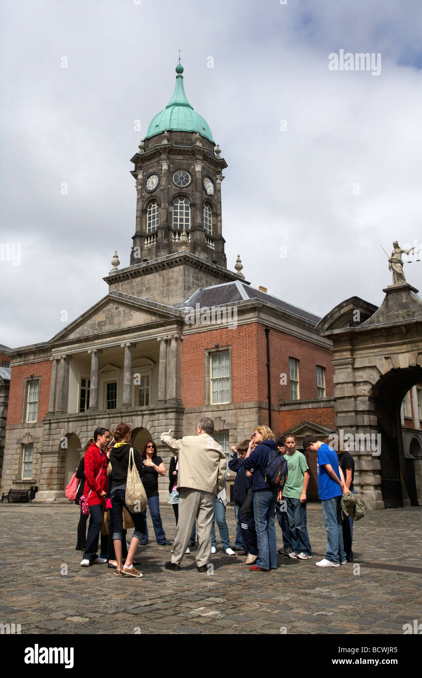 organised tour group of tourists in the the great courtyard upper courtyard in front of the bedford tower in dublin castle Stock Photo