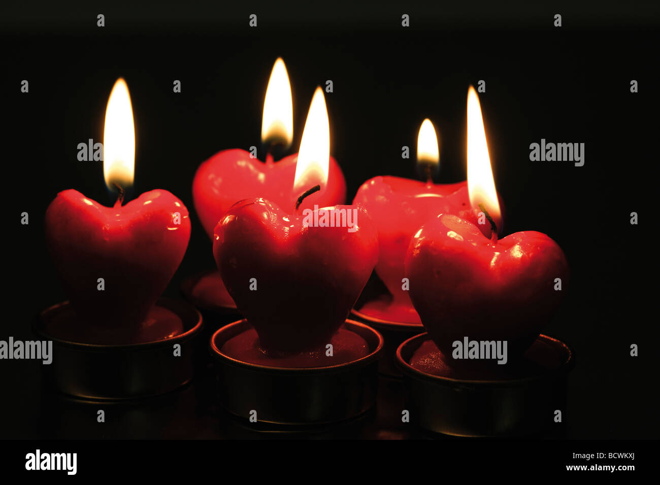 Burning red heart candles Stock Photo Alamy