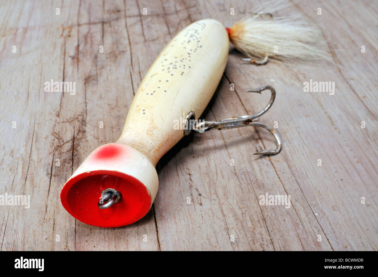 Salt water fishing lure on wood a plug or popper type lure Stock