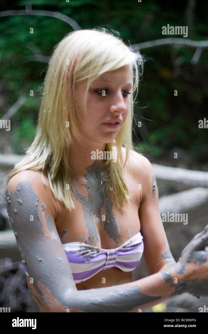 Pretty teenage girl playing in mud Stock Photo